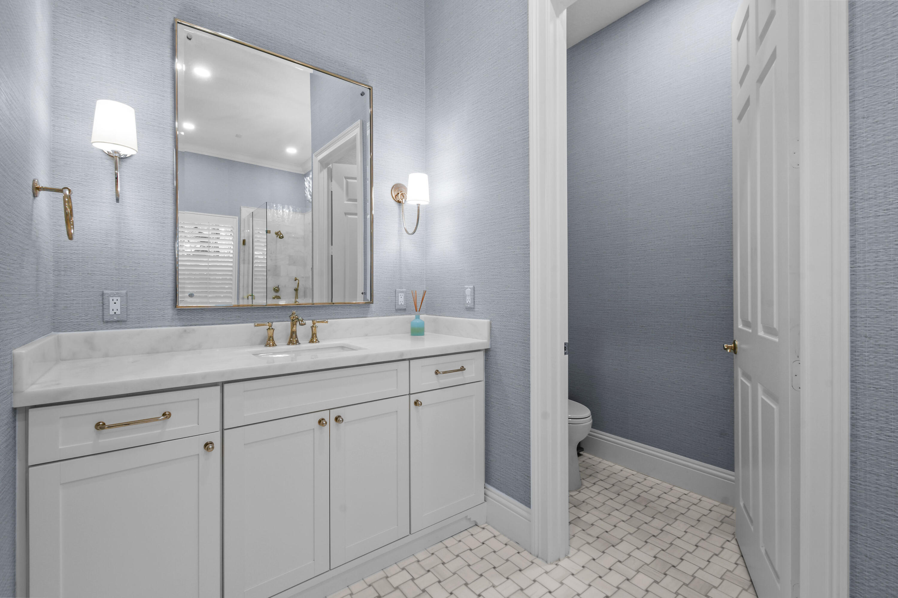 111 Bilboa Drive Jupiter, FL 33458 - Photo 25 of 35 a bathroom with a granite countertop sink a toilet and a mirror