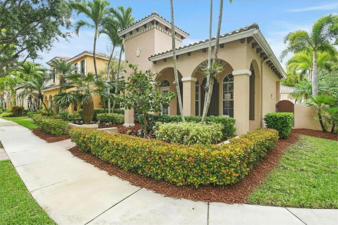 111 Bilboa Drive Jupiter, FL 33458 - Photo 3 of 35 a front view of a house with garden