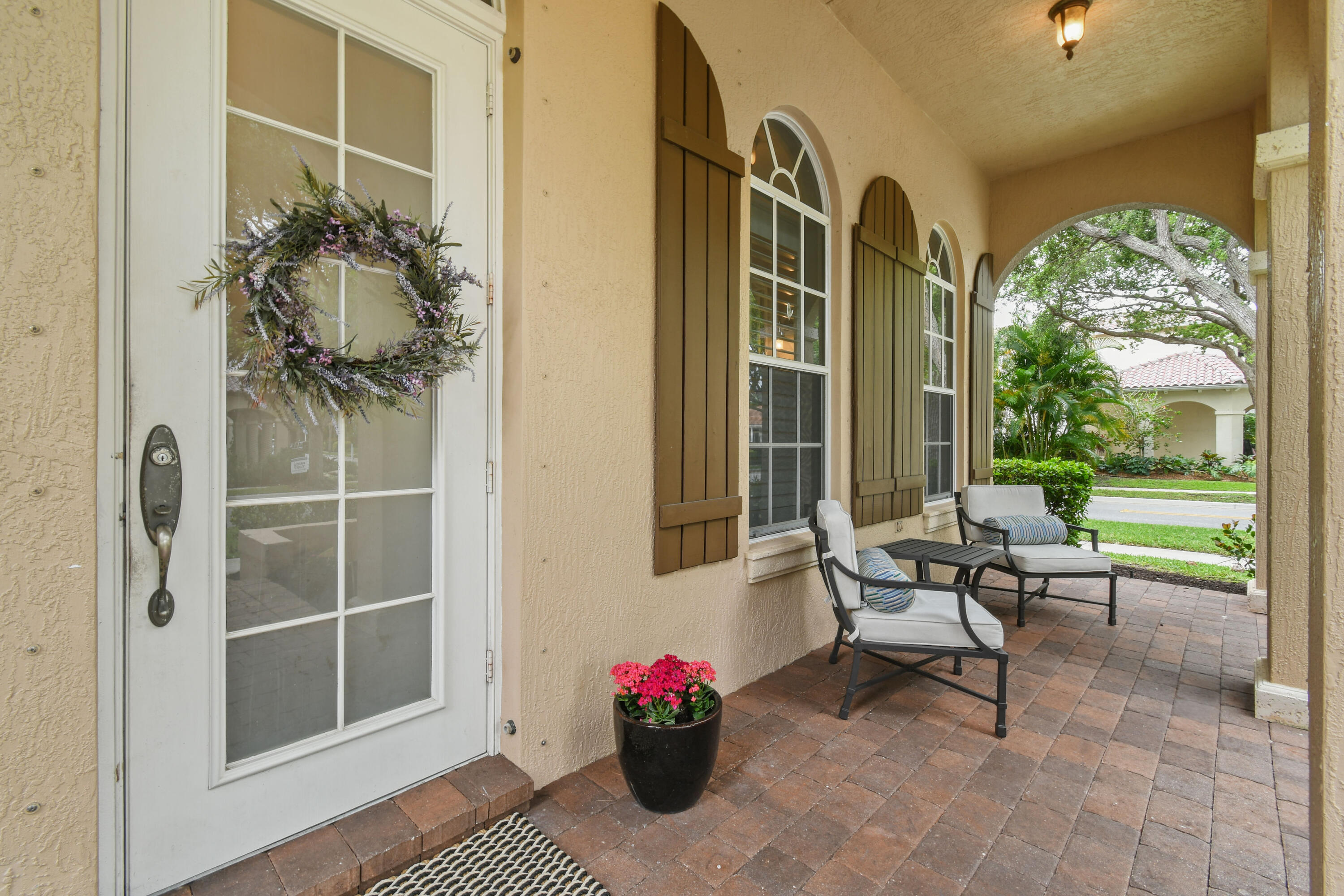 111 Bilboa Drive Jupiter, FL 33458 - Photo 4 of 35 a house view with a seating space and a bench