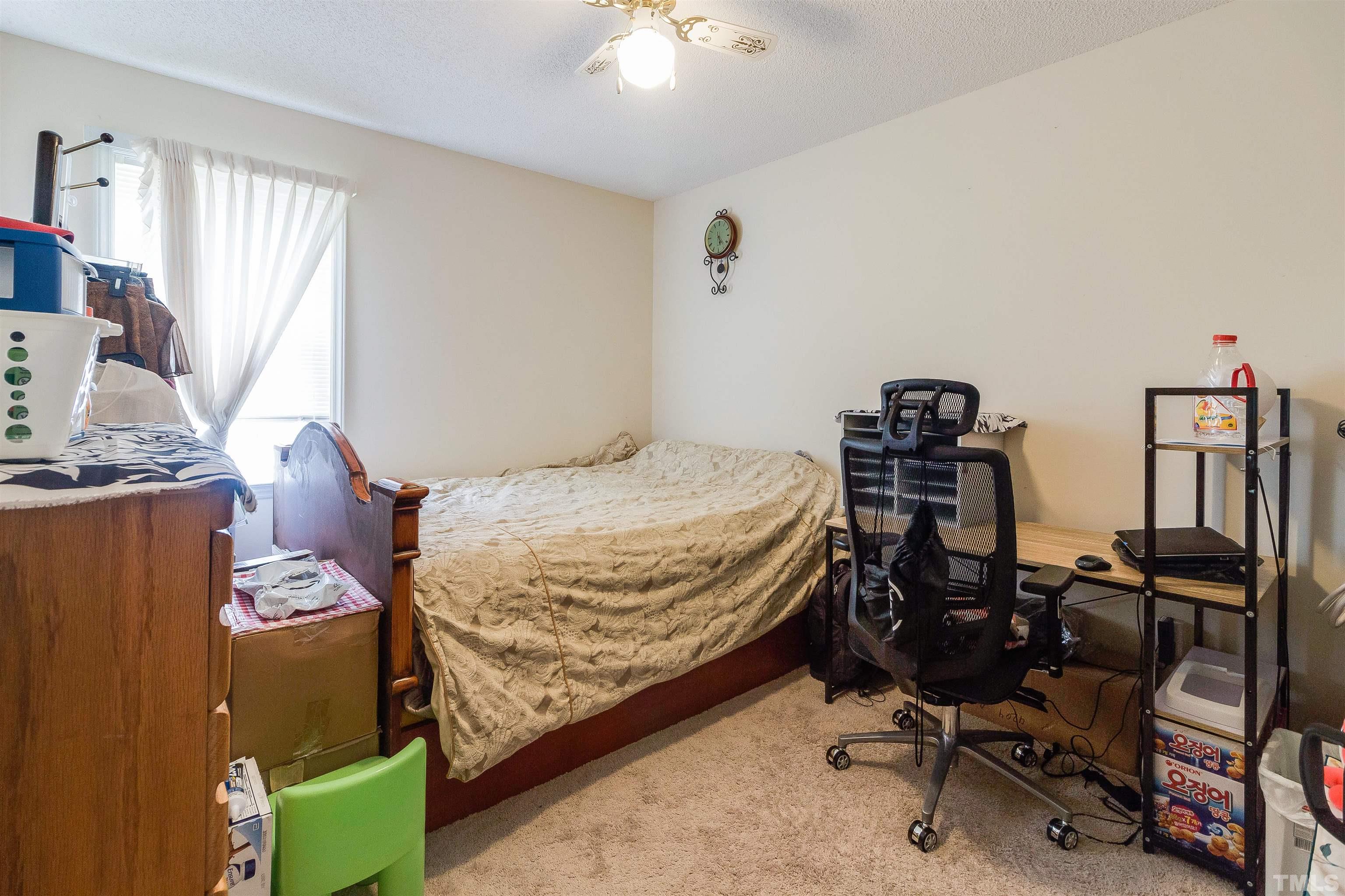 4216 Wolftrap Road Raleigh, NC 27616 - Photo 11 of 20 a bedroom with a bed and a chandelier