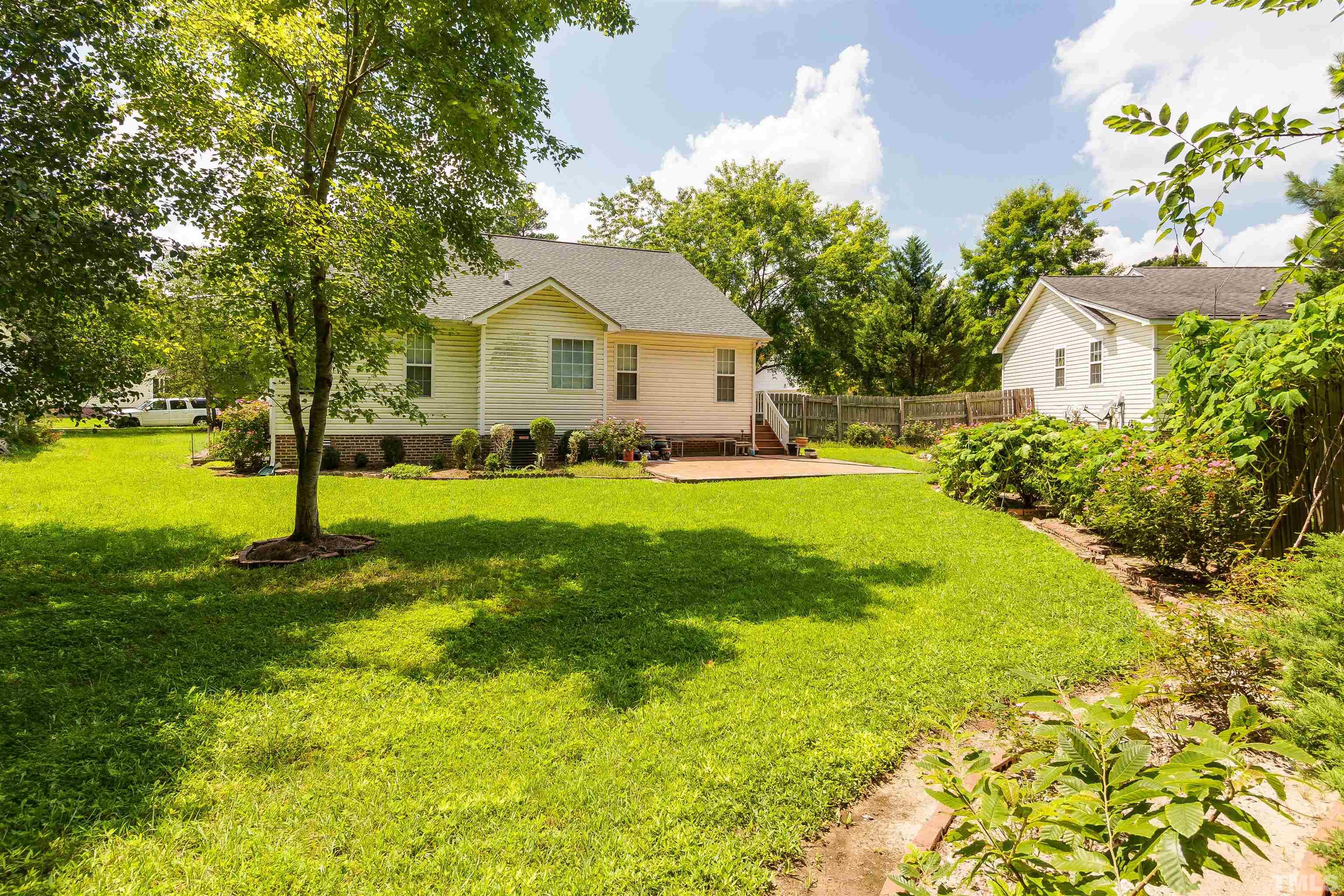 4216 Wolftrap Road Raleigh, NC 27616 - Photo 15 of 20 a front view of a house with yard and green space