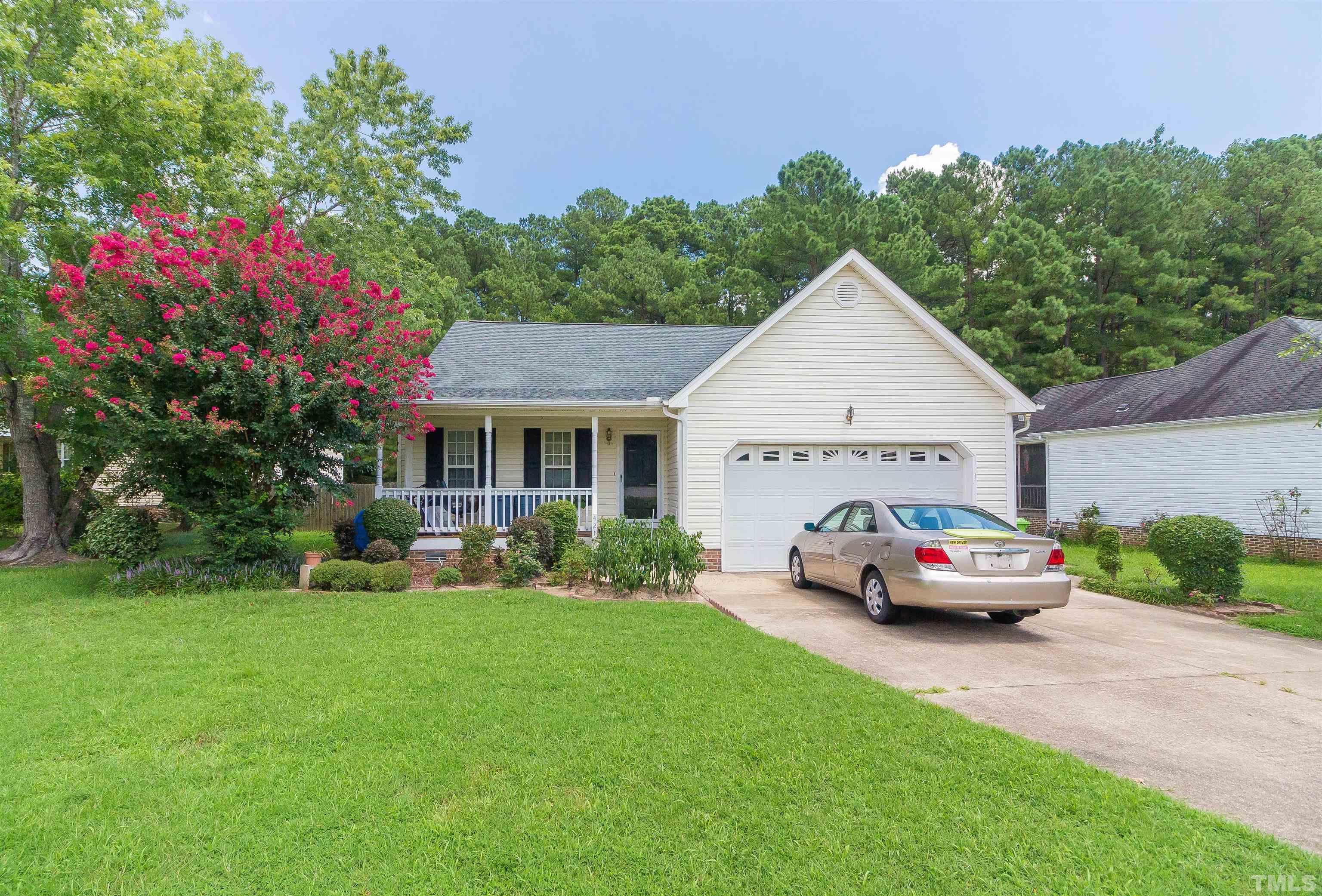 4216 Wolftrap Road Raleigh, NC 27616 - Photo 18 of 20 a car parked in front of a house next to a yard