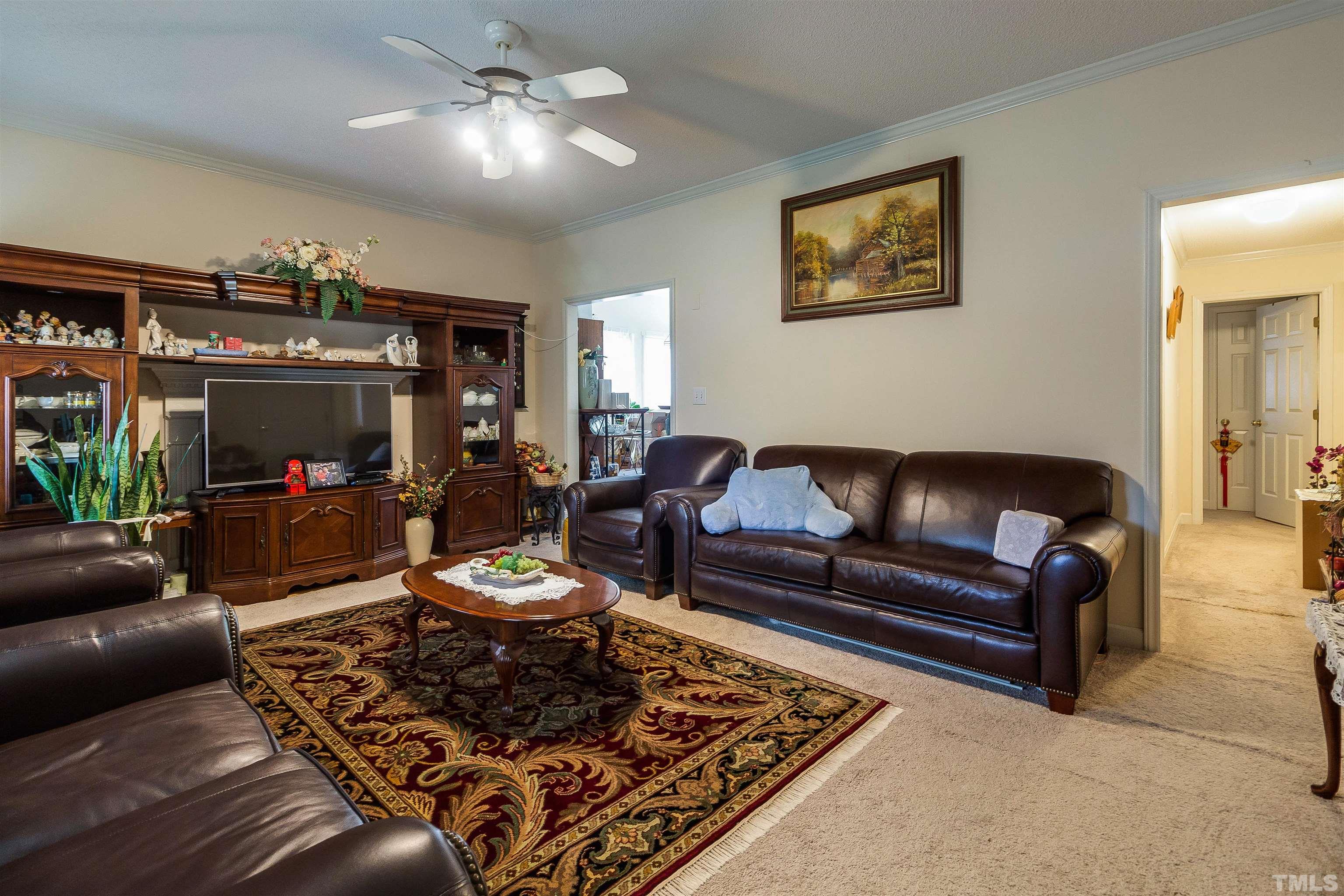 4216 Wolftrap Road Raleigh, NC 27616 - Photo 3 of 20 a living room with furniture and a chandelier