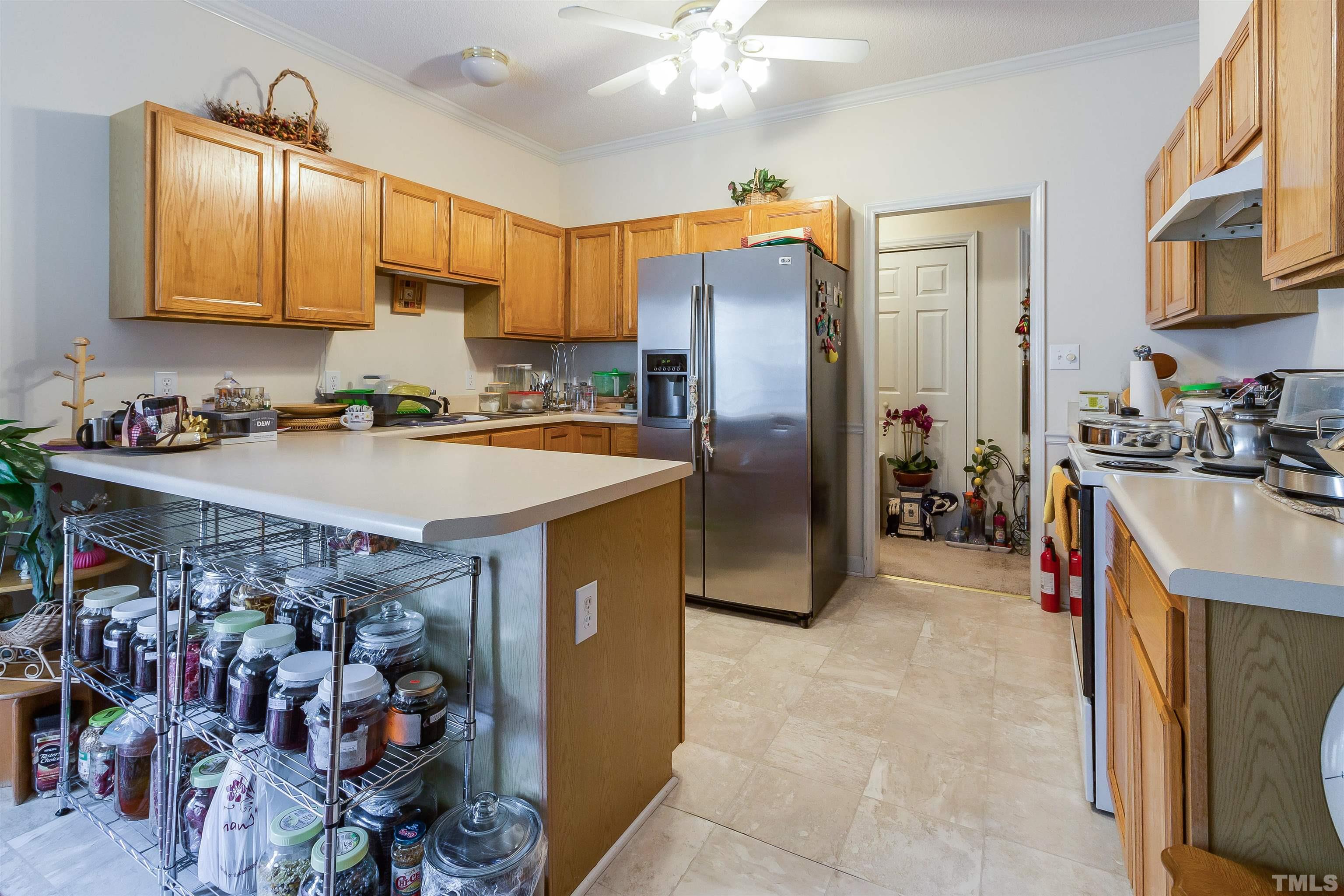 4216 Wolftrap Road Raleigh, NC 27616 - Photo 5 of 20 a kitchen with a sink a stove and cabinets