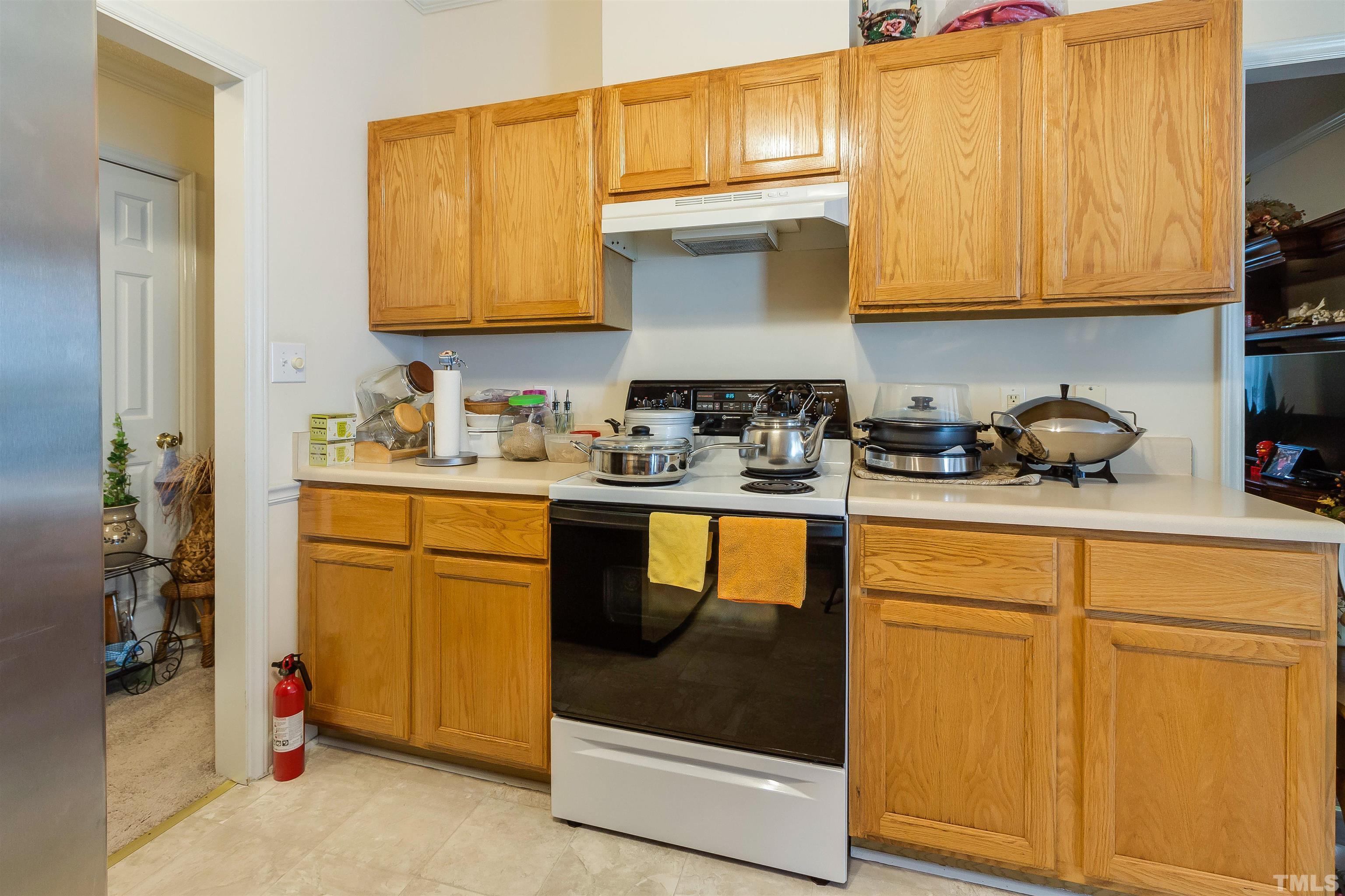 4216 Wolftrap Road Raleigh, NC 27616 - Photo 7 of 20 a kitchen with stainless steel appliances granite countertop a sink stove and cabinets