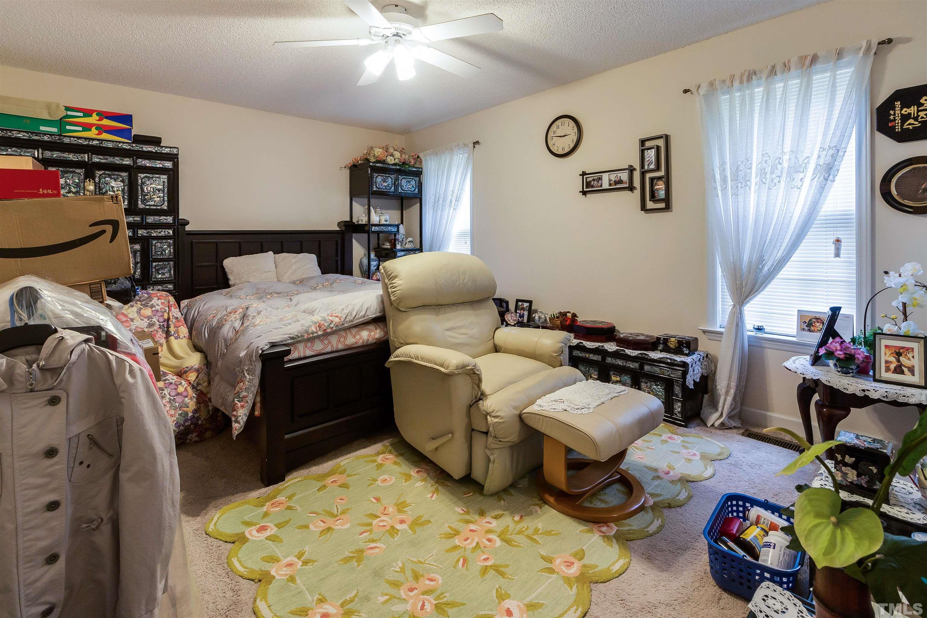 4216 Wolftrap Road Raleigh, NC 27616 - Photo 8 of 20 a bedroom with bed and a chandelier