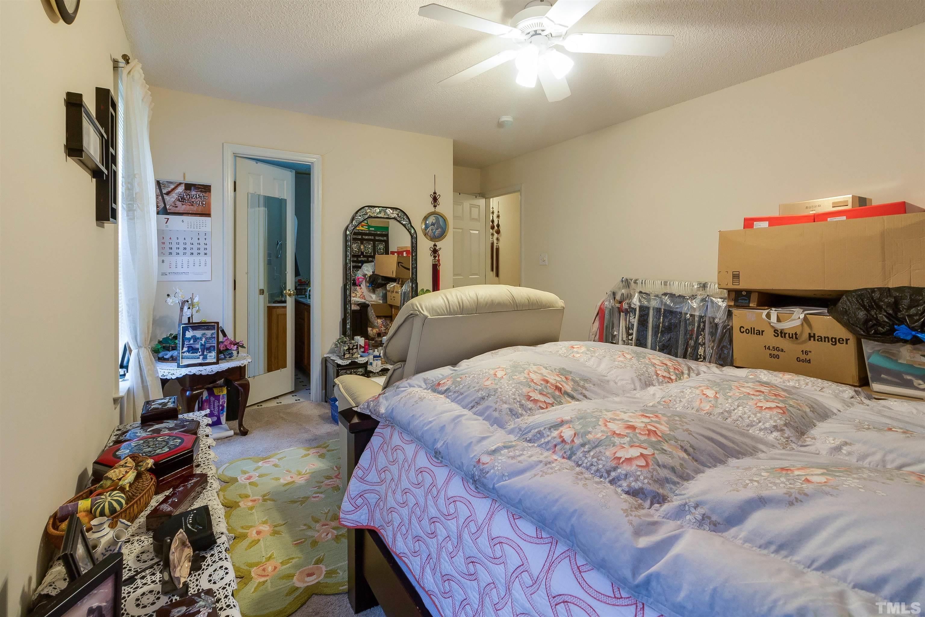 4216 Wolftrap Road Raleigh, NC 27616 - Photo 9 of 20 a bed room with a bed window and a chair
