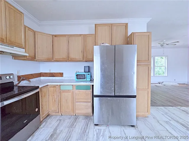 a kitchen with a refrigerator sink and cabinets
