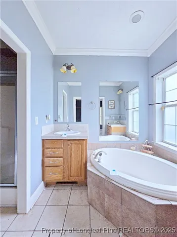 a spacious bathroom with a tub sink and mirror