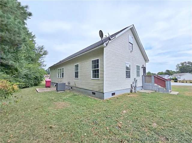a view of a house with a yard and deck