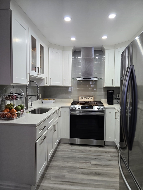 100 Bailey Street, Unit 1 Lawrence, MA 01843 - Photo 8 of 8 a kitchen with stainless steel appliances granite countertop a stove a sink and a refrigerator