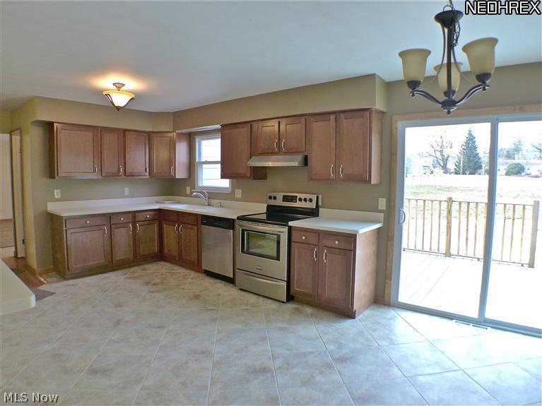 832 North Road Southeast Warren, OH 44484 - Photo 3 of 14 Brand new kitchen cabinets, with corian counter tops,new stainless steel appliances, and ceramic tile floor