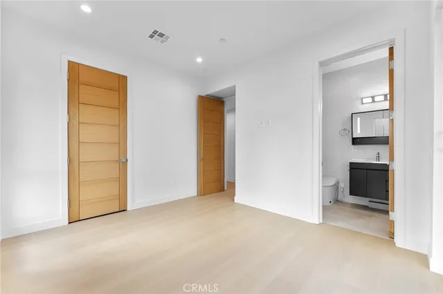 a dining room with furniture a large window and a potted plant