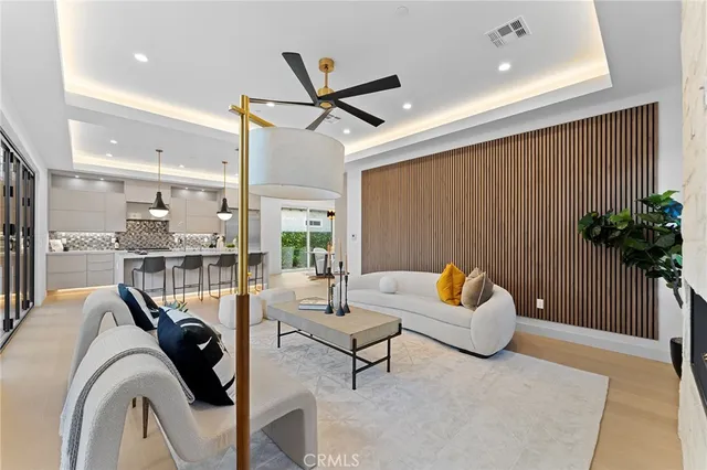 a large kitchen with stainless steel appliances a large counter top a stove a chimney a sink and a refrigerator