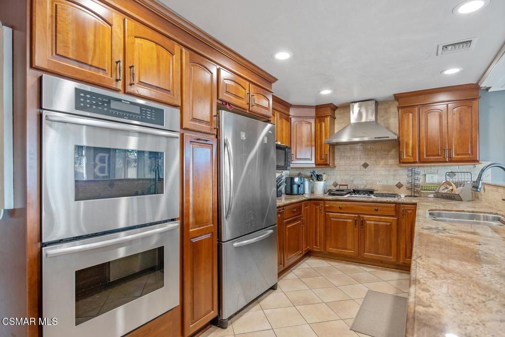 4787 North Buttercreek Road Moorpark, CA 93021 - Photo 11 of 31 a kitchen with stainless steel appliances granite countertop a refrigerator and a stove top oven