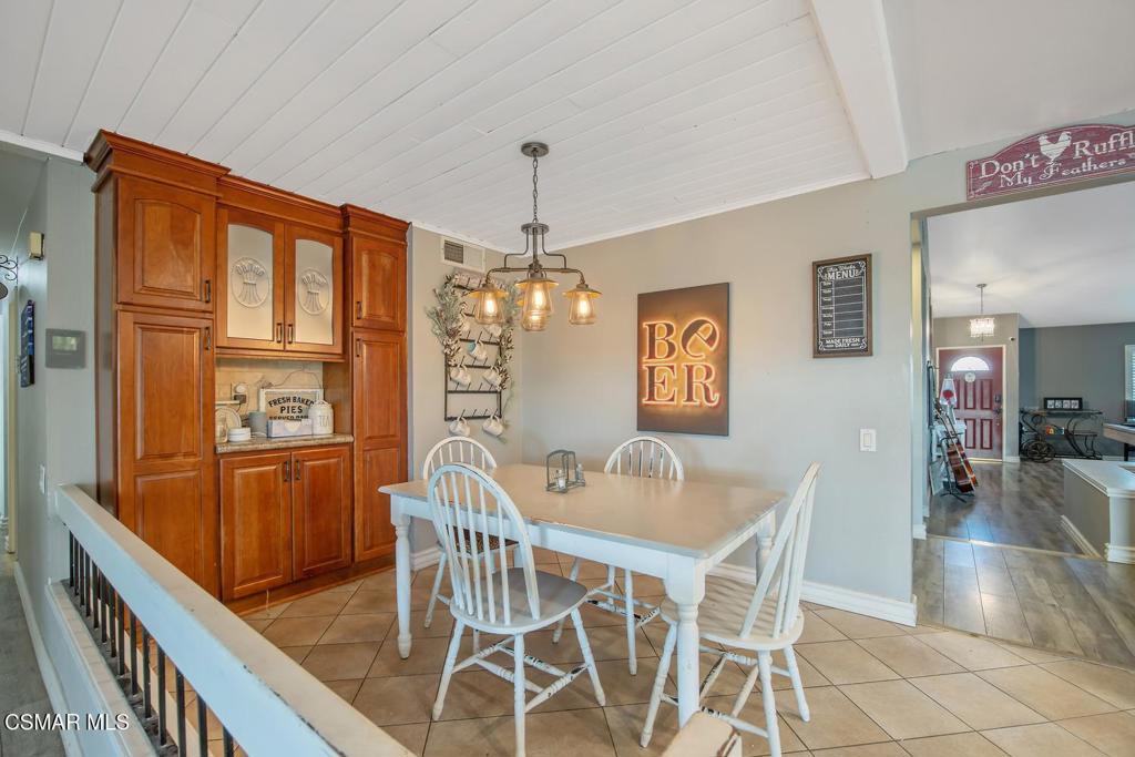 4787 North Buttercreek Road Moorpark, CA 93021 - Photo 17 of 31 a dining room with furniture a chandelier and window