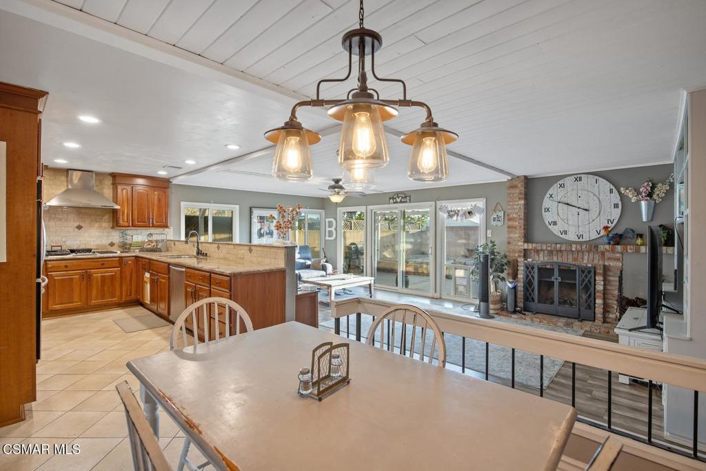 4787 North Buttercreek Road Moorpark, CA 93021 - Photo 18 of 31 a view of a dining room and livingroom with furniture wooden floor a chandelier