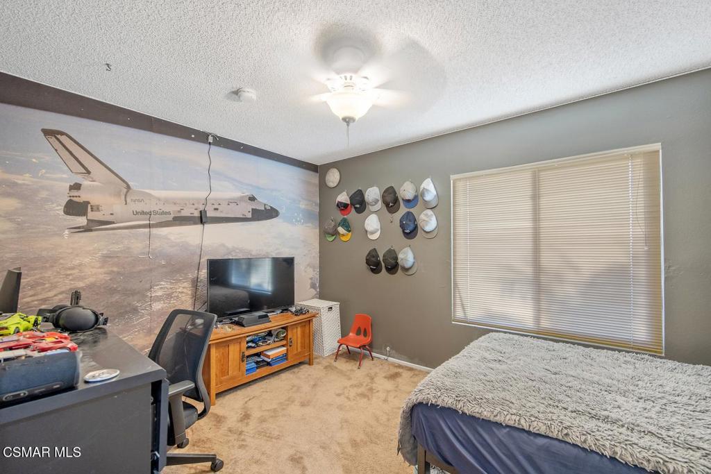 4787 North Buttercreek Road Moorpark, CA 93021 - Photo 19 of 31 a bedroom with furniture and a flat screen tv
