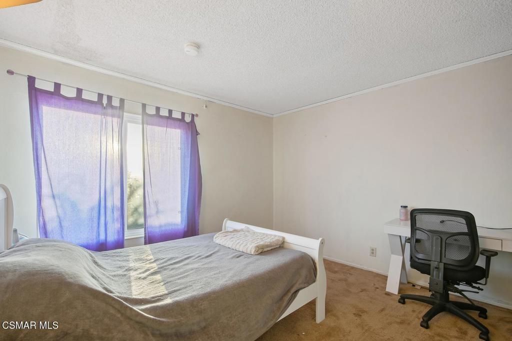 4787 North Buttercreek Road Moorpark, CA 93021 - Photo 20 of 31 a bedroom with a bed and a chair