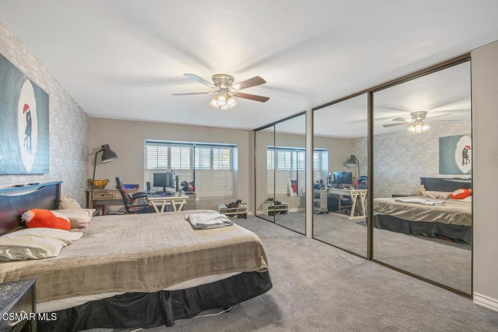 4787 North Buttercreek Road Moorpark, CA 93021 - Photo 24 of 31 a bedroom with a large bed and a chandelier