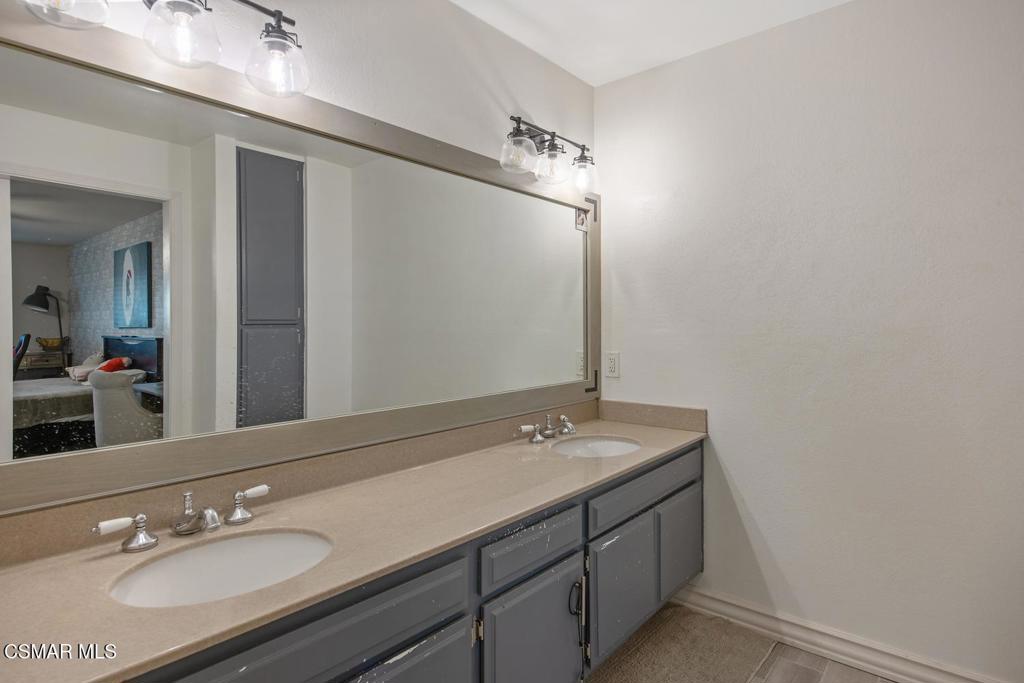4787 North Buttercreek Road Moorpark, CA 93021 - Photo 25 of 31 a bathroom with a sink double vanity and a mirror