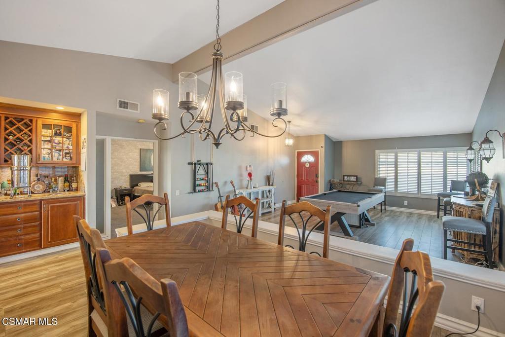 4787 North Buttercreek Road Moorpark, CA 93021 - Photo 10 of 31 a view of a dining room and livingroom with furniture wooden floor a rug a painting and a chandelier