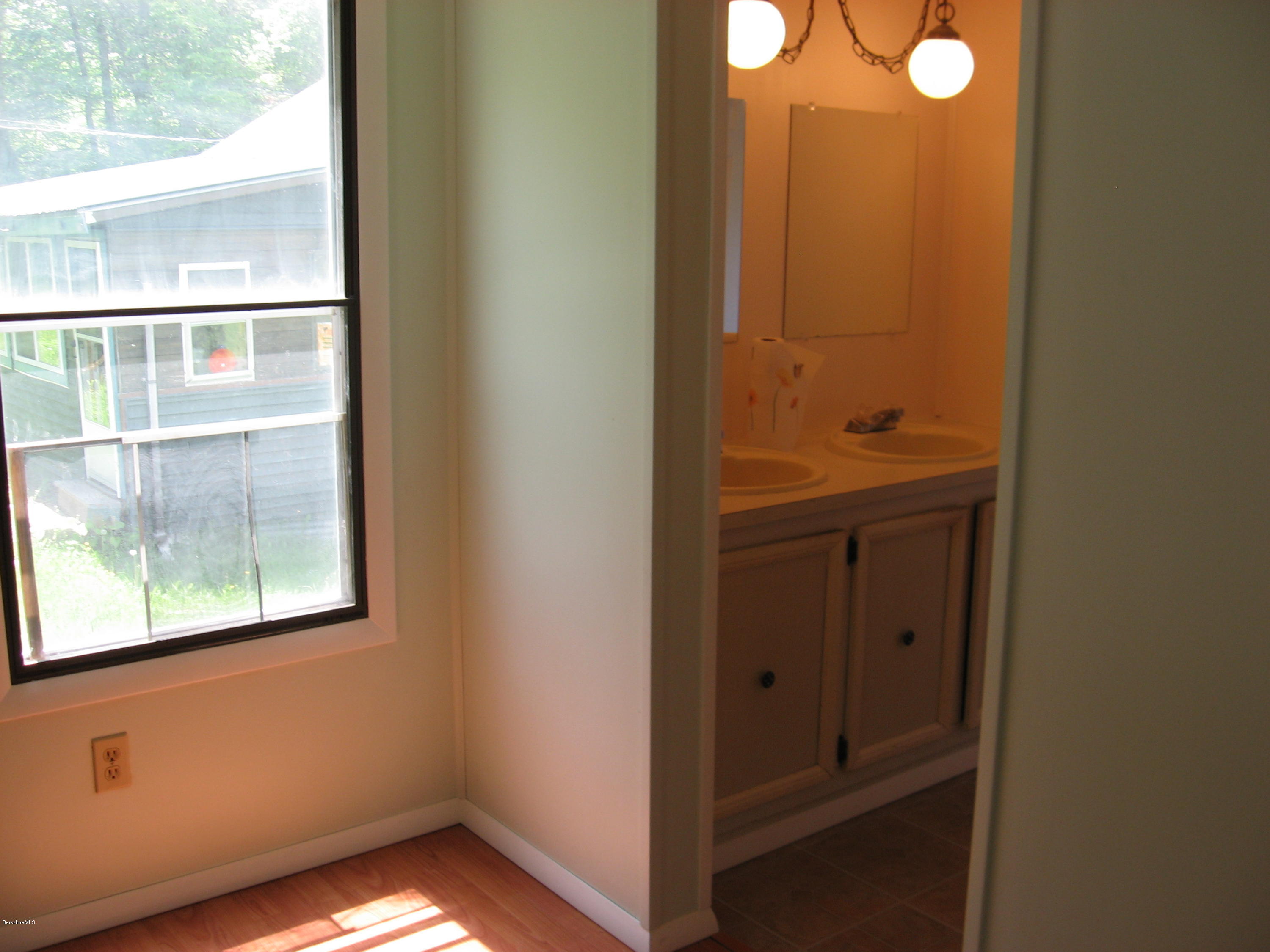 24 Access 3 Road Savoy, MA 01256 - Photo 16 of 19 a view of an empty room with wooden floor and windows