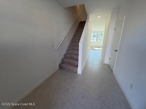 a view of a hallway with stairs