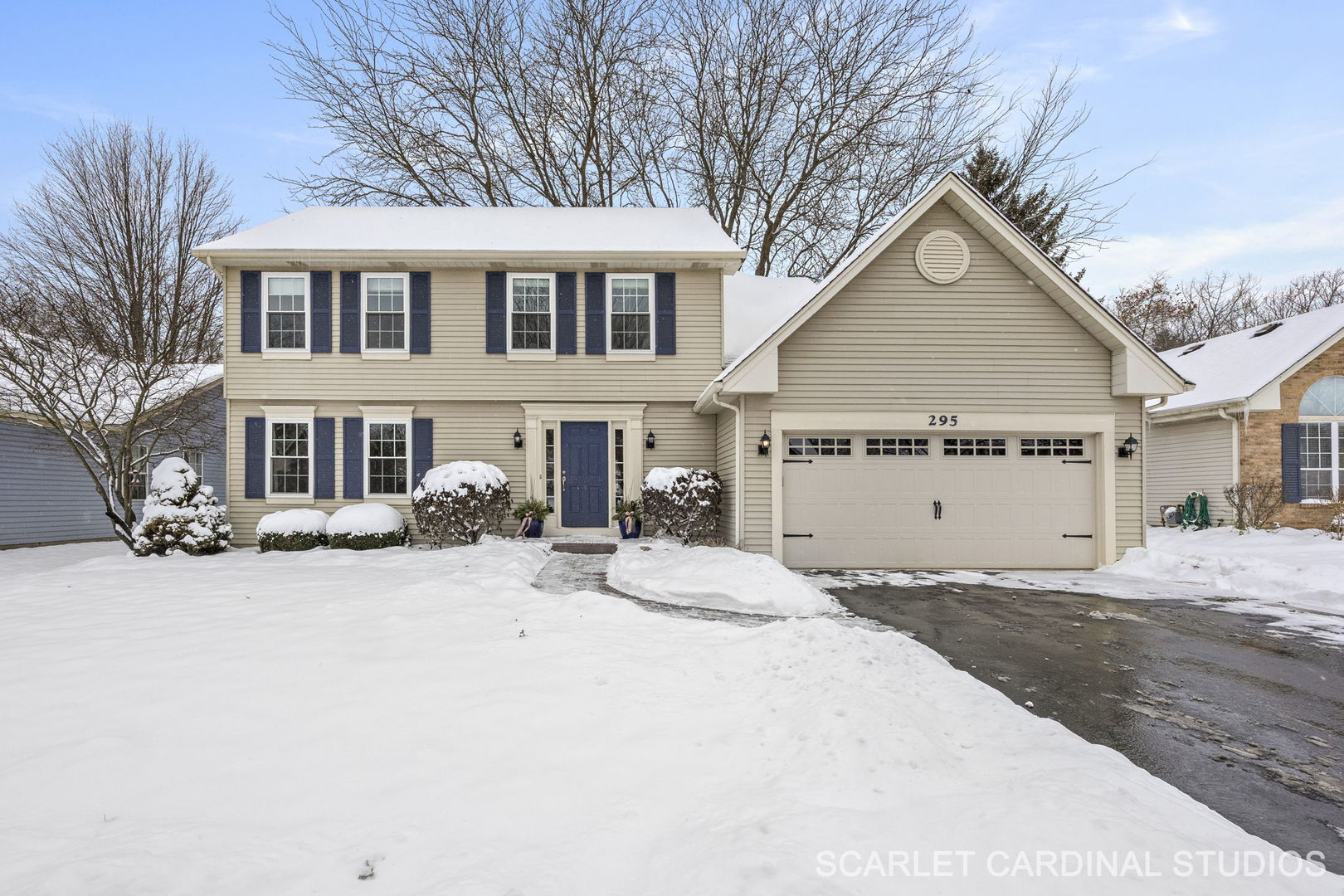 a view of a house with a yard covered in snow