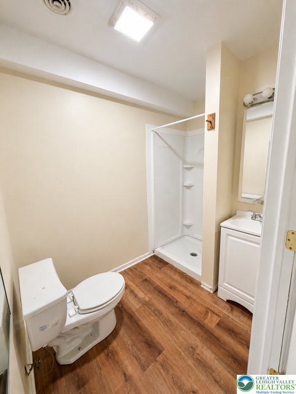 3496 Linden Street, Unit UPPR Bethlehem, PA 18017 - Photo 2 of 9 Functional full bathroom with shower, toilet, and vanity on rich hardwood flooring.