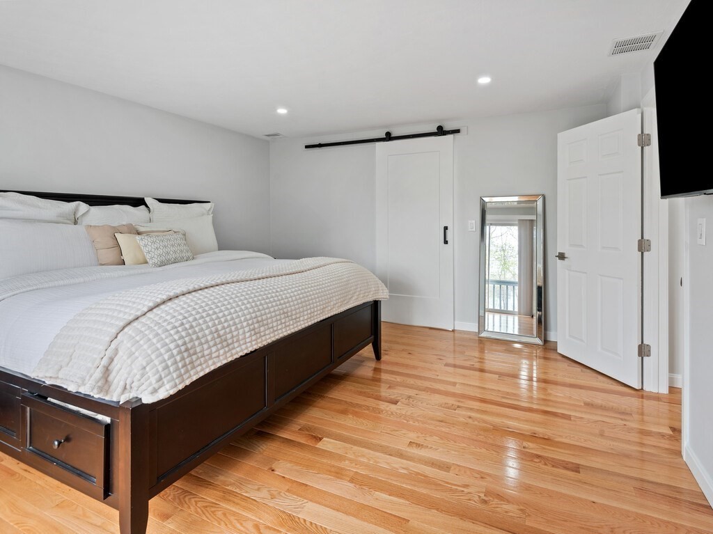 2 Stringer Dam Road Shrewsbury, MA 01545 - Photo 20 of 35 a spacious bedroom with a bed and a flat screen tv