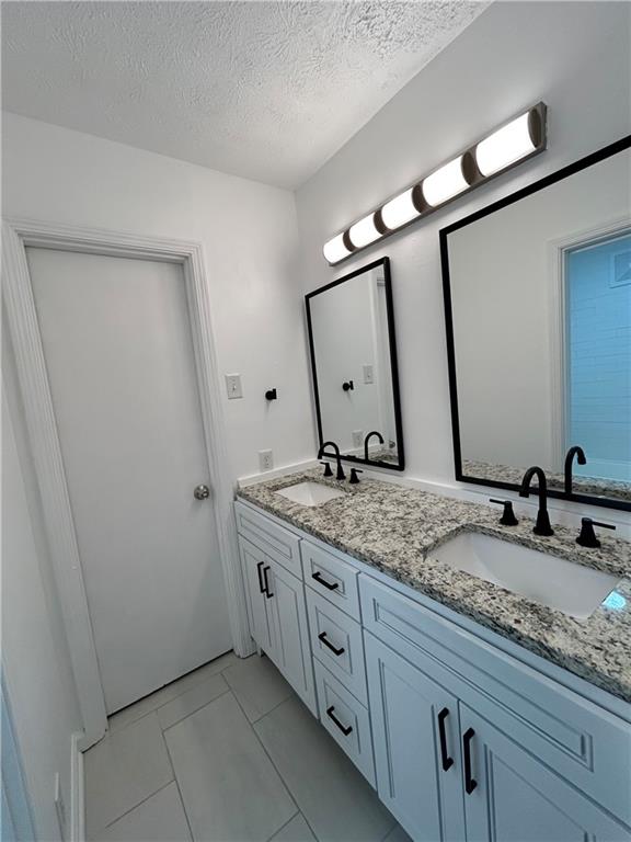 1822 North Rock Springs Road Northeast, Unit 7 Atlanta, GA 30324 - Photo 11 of 21 a bathroom with a granite countertop sink and a mirror