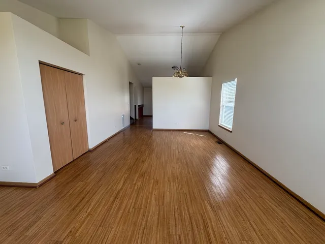 a view of a room with wooden floor and white walls