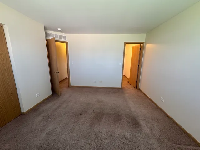 a view of an empty room with a closet
