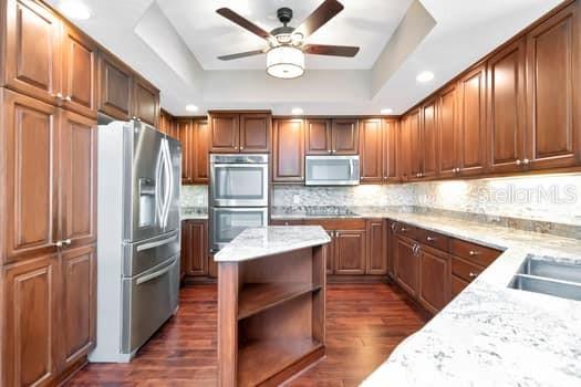 3507 Bayshore Boulevard, Unit 302 Tampa, FL 33629 - Photo 11 of 47 a kitchen with kitchen island granite countertop a refrigerator stove and sink
