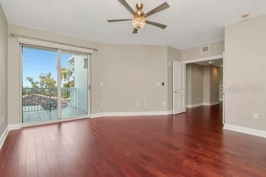 a view of a livingroom with wooden floor and a ceiling fan