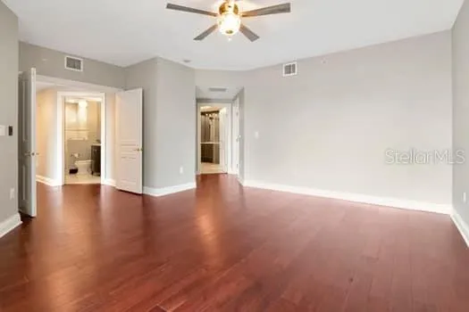 wooden floor in an empty room with a window
