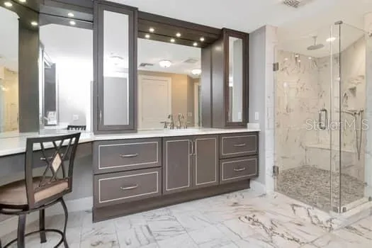 a bathroom with a sink vanity and mirror