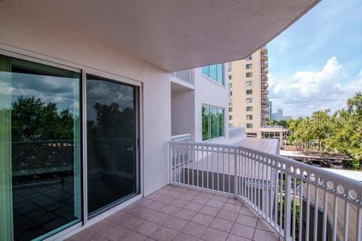 3507 Bayshore Boulevard, Unit 302 Tampa, FL 33629 - Photo 26 of 47 a view of a balcony with a floor to ceiling window and wooden fence