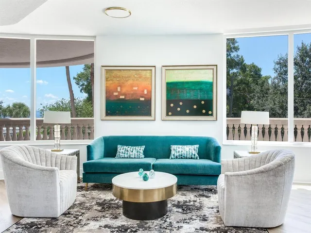 a living room with furniture a rug and a potted plant