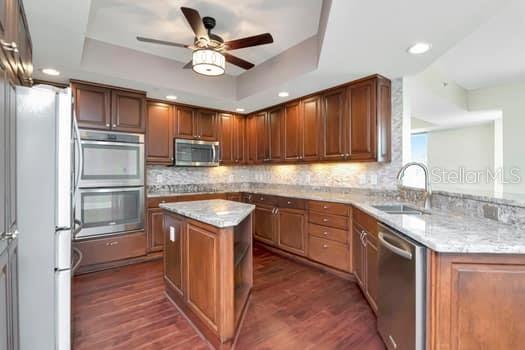 3507 Bayshore Boulevard, Unit 302 Tampa, FL 33629 - Photo 10 of 47 a kitchen with stainless steel appliances granite countertop a sink stove microwave and refrigerator