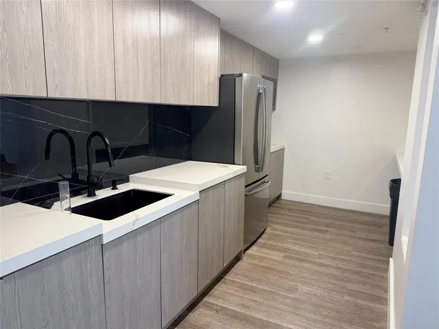 a kitchen with a sink and a refrigerator