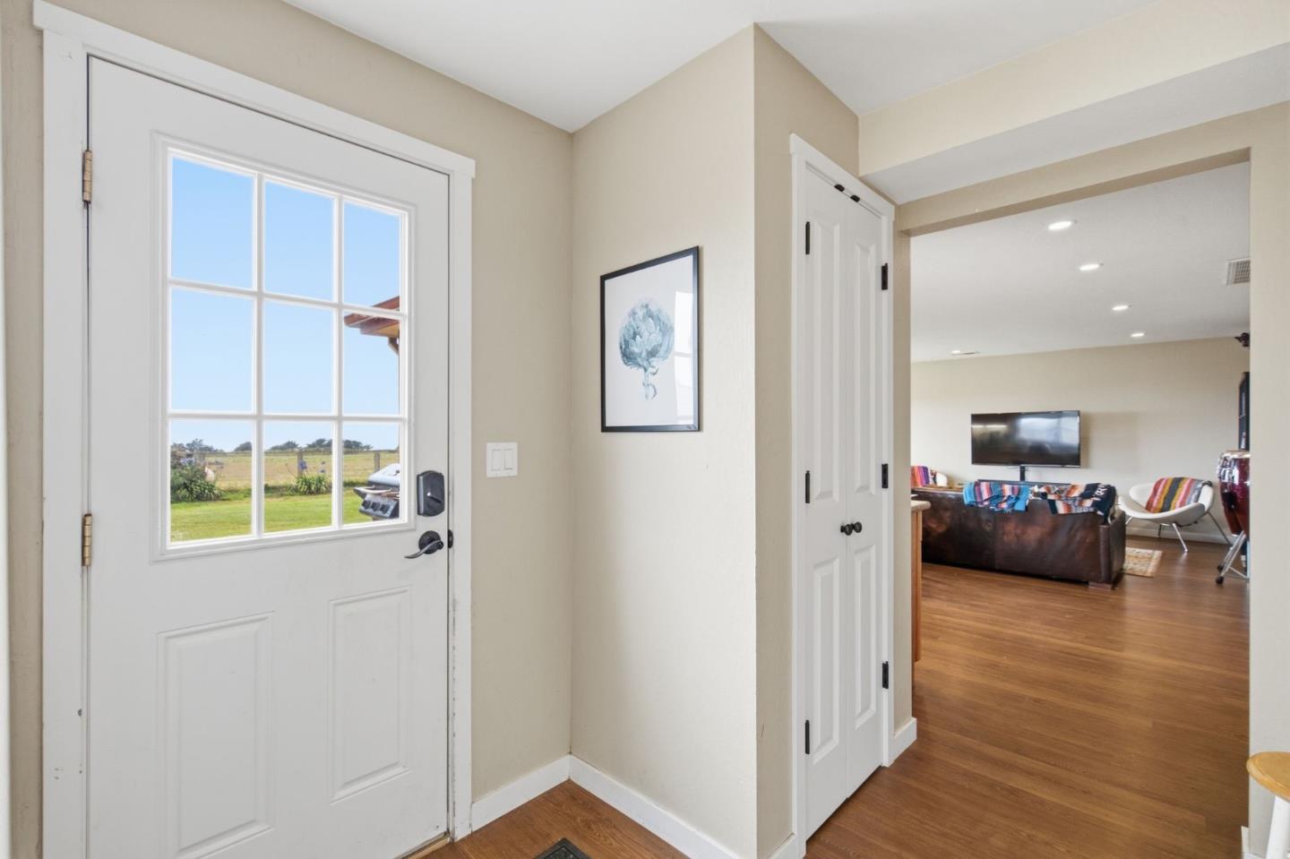 1263 Reservoir Road Pescadero, CA 94060 - Photo 47 of 66 a view of a hallway with wooden floor and windows in a room