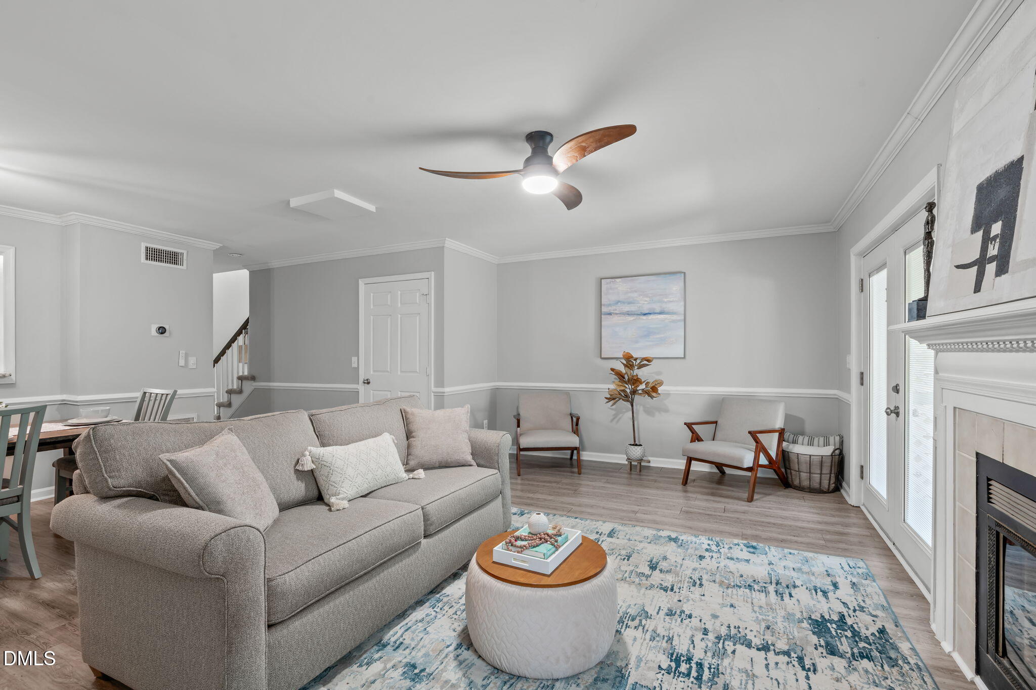203 Oak Hollow Court Raleigh, NC 27613 - Photo 14 of 37 a living room with furniture a fireplace and a chandelier