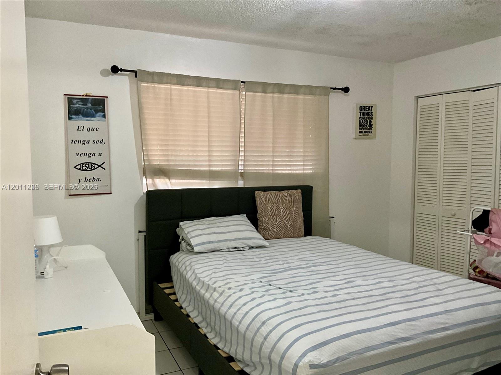 1910 West 56th Street, Unit 3226 Hialeah, FL 33012 - Photo 13 of 21 a bedroom with a bed and a window