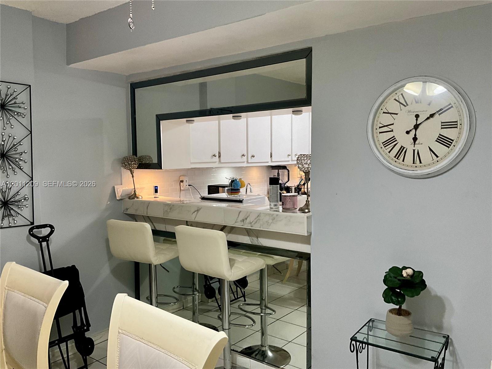 1910 West 56th Street, Unit 3226 Hialeah, FL 33012 - Photo 15 of 21 a kitchen with a table and chairs in it
