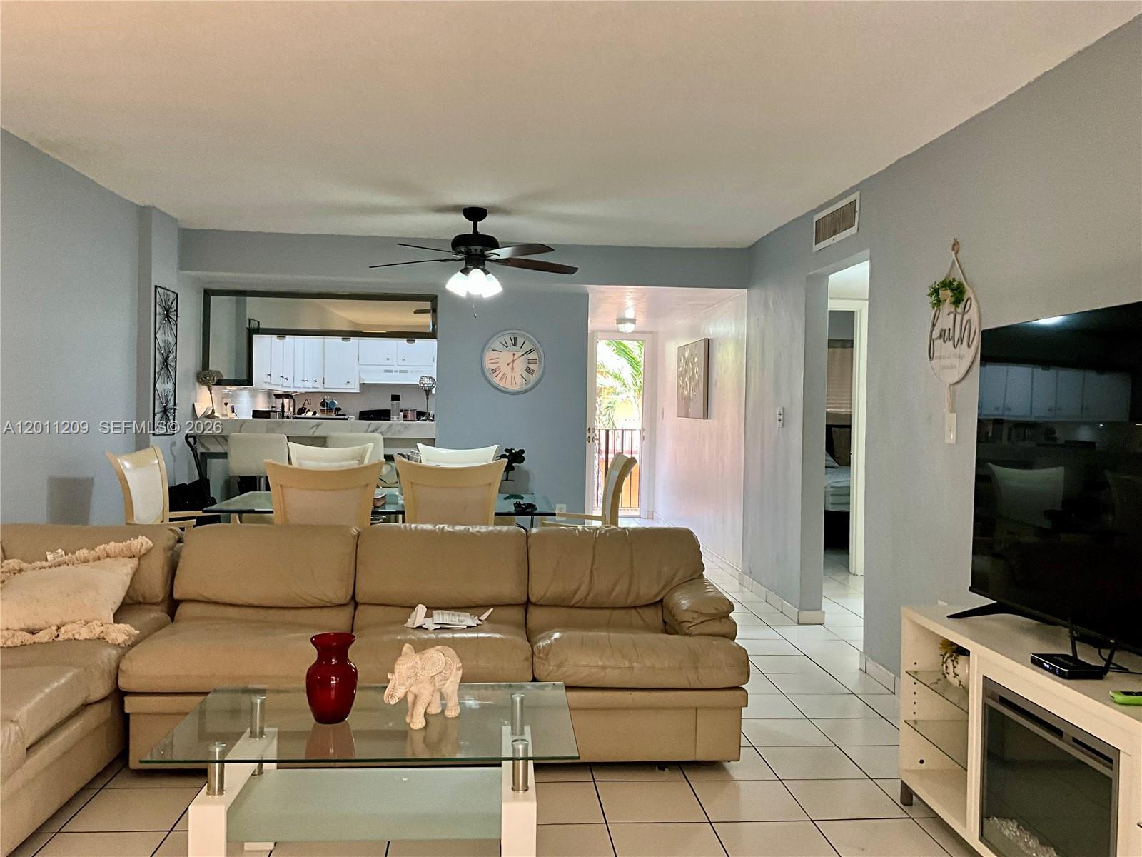 1910 West 56th Street, Unit 3226 Hialeah, FL 33012 - Photo 5 of 21 a living room with furniture and a flat screen tv