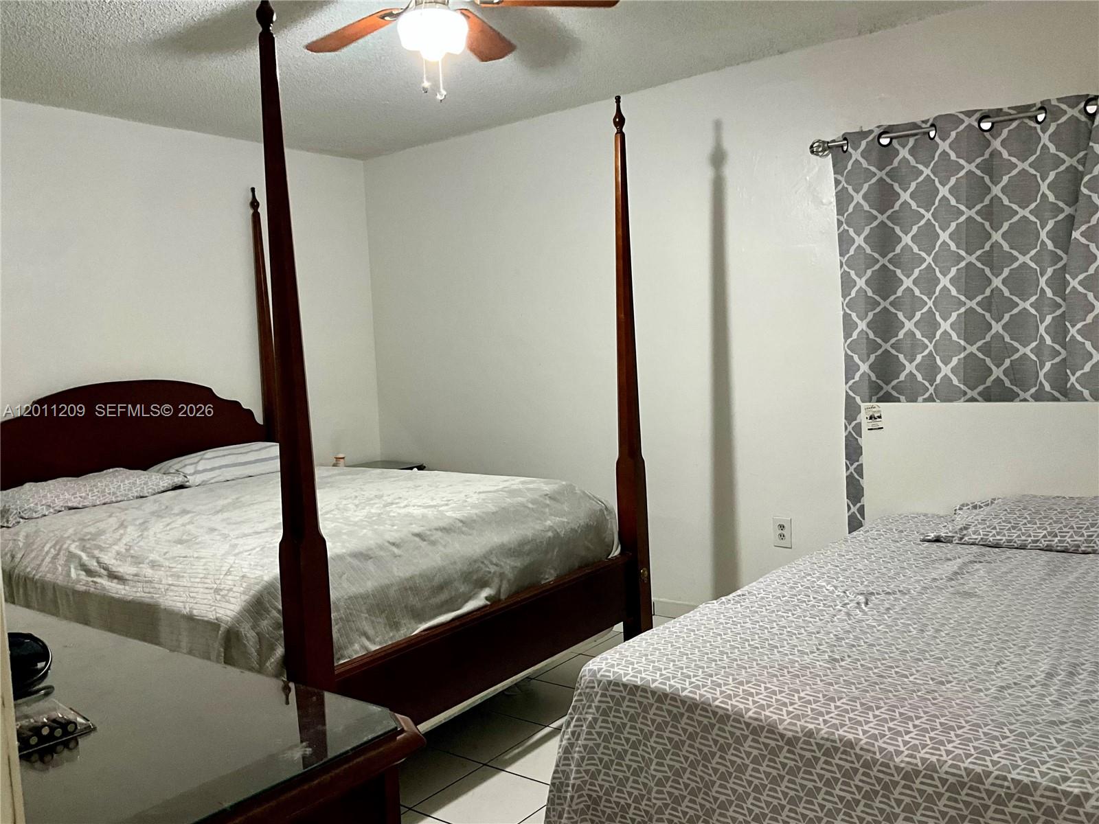 1910 West 56th Street, Unit 3226 Hialeah, FL 33012 - Photo 10 of 21 a bedroom with a bed and a chandelier