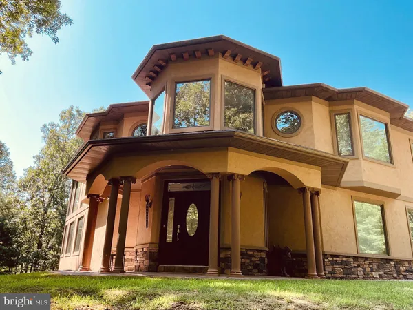 a view of a wooden door with a small yard