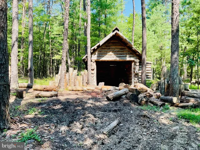 an aerial view of a house with a yard and tennis court